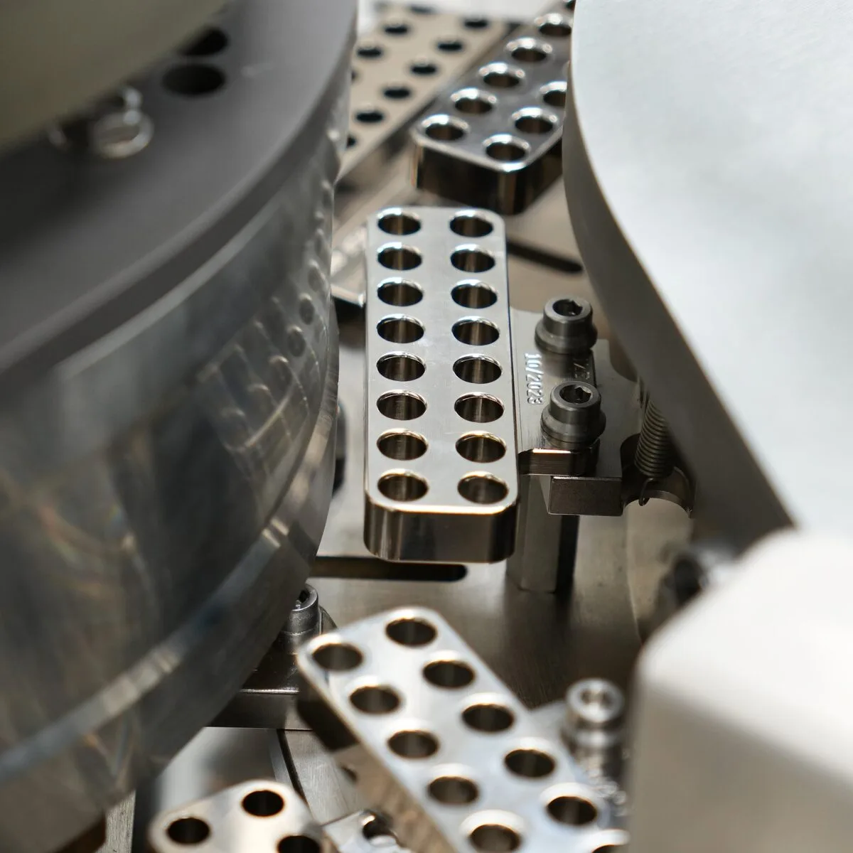 Close-up of automated hard capsule filling tooling at Eagle Works nutraceutical contract manufacturing facility Logan Utah
